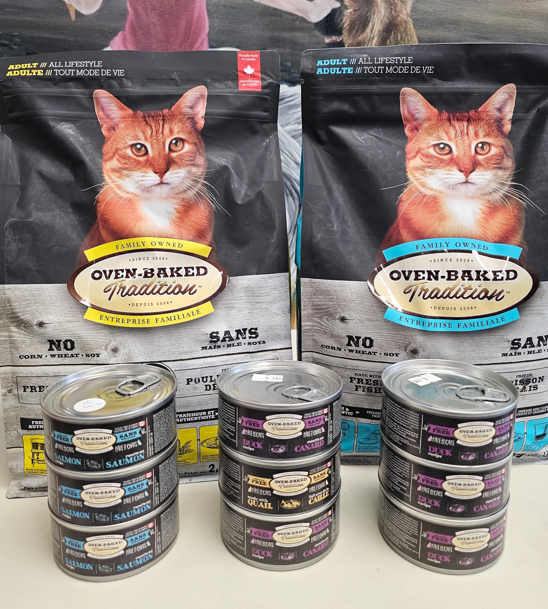 Colorful assortment of Oven Baked Tradition cat products on shelves at East Coast Pets