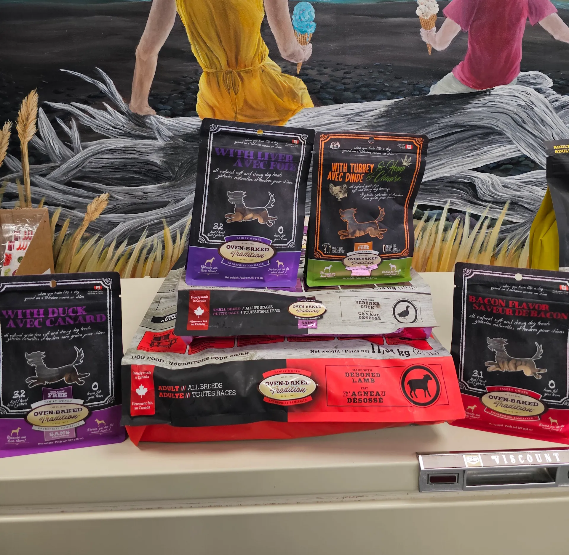 Colorful assortment of Oven Baked Tradition dog products on shelves at East Coast Pets